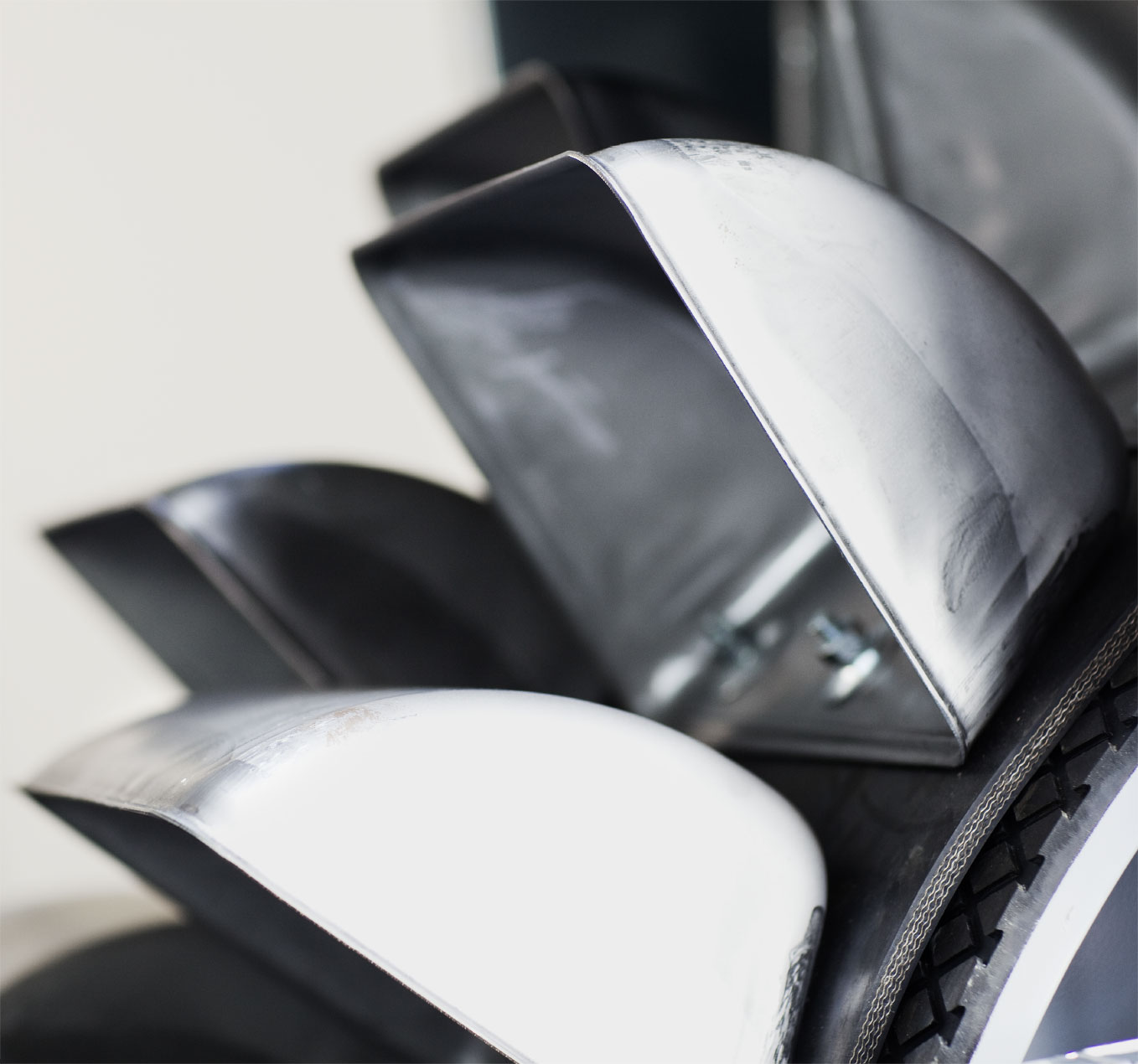 Close-up of shiny metallic parts stacked together.