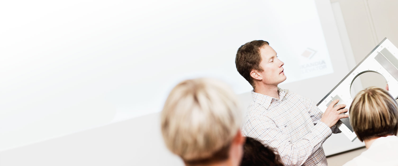 A man is giving a presentation to a group of people.